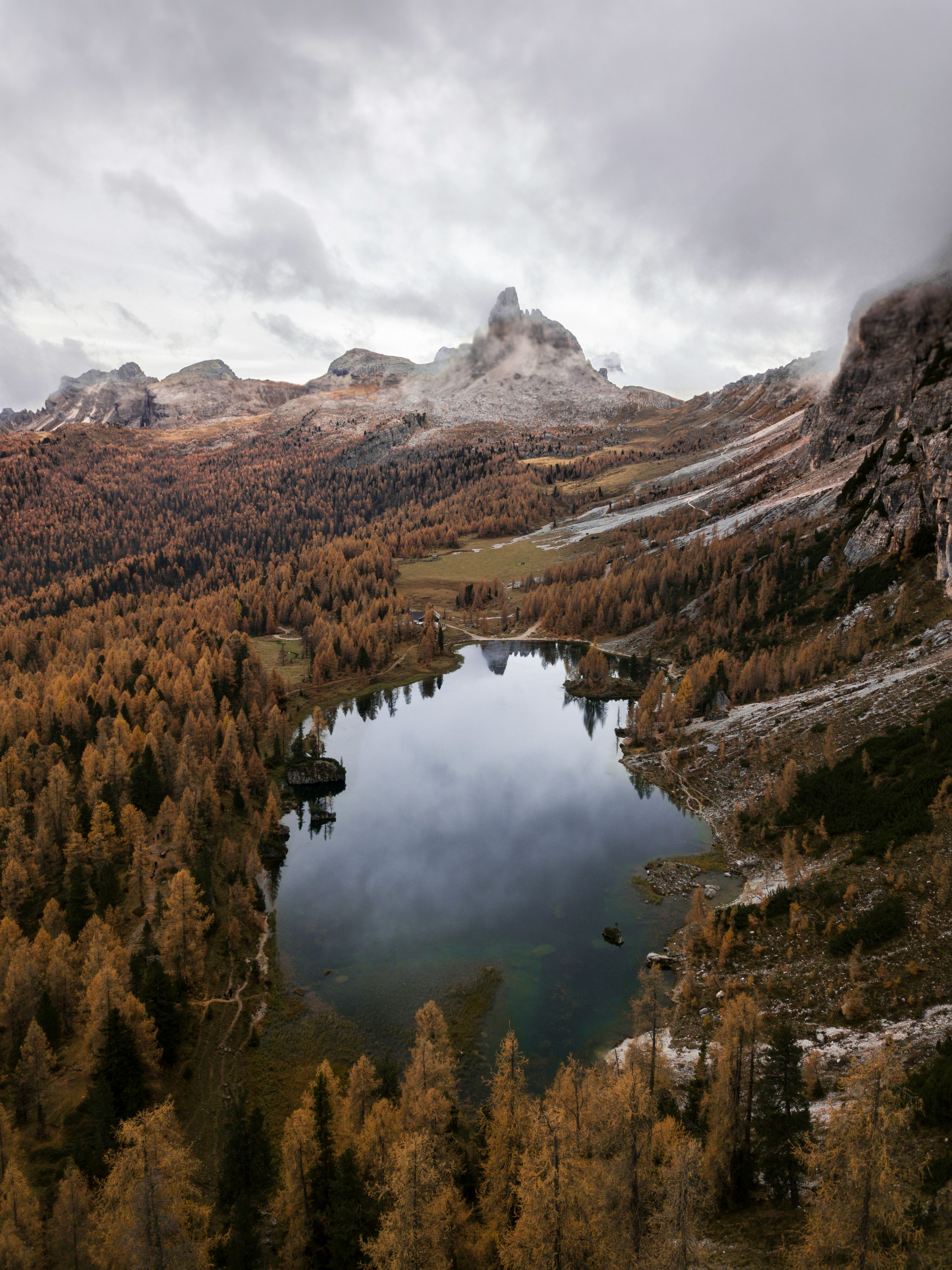 aerial view of lake surrounded with trees and mountains